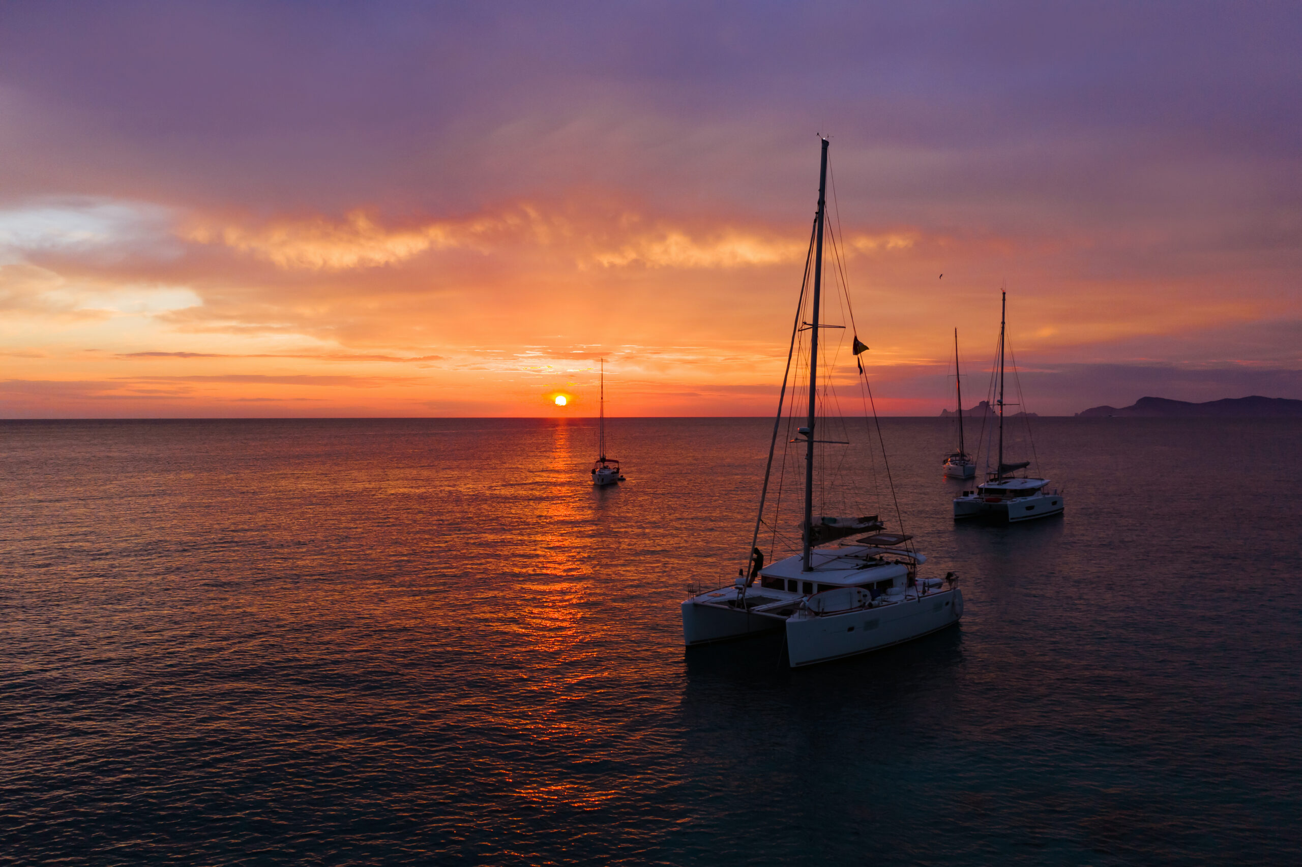 Aerial view from drone on boats shipping in sea, sunset. Yachting with a dramatic sunset as backdrop