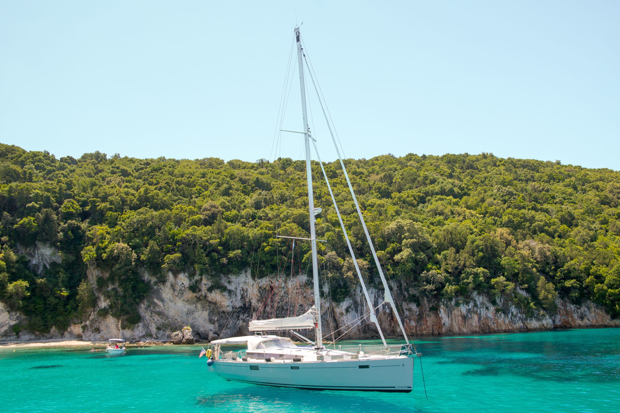 A white yacht sailing in the turquoise lagoon on a sunny day